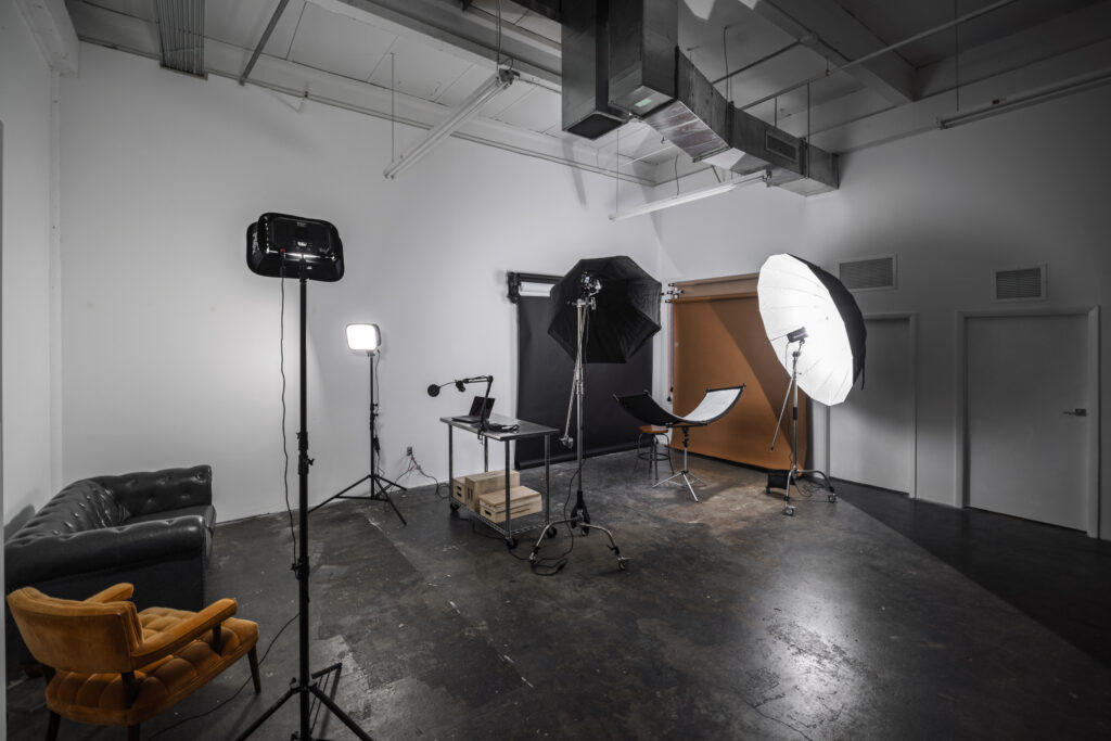 Studio 4 a photo studio with a chair and a flash